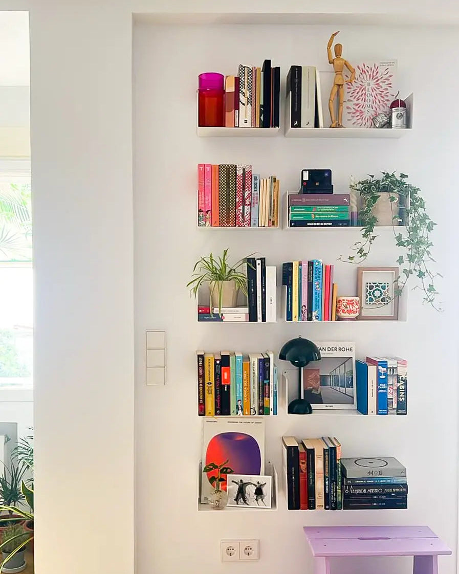 modern vertical design floating white wall shelves with books, plants, and decorative objects